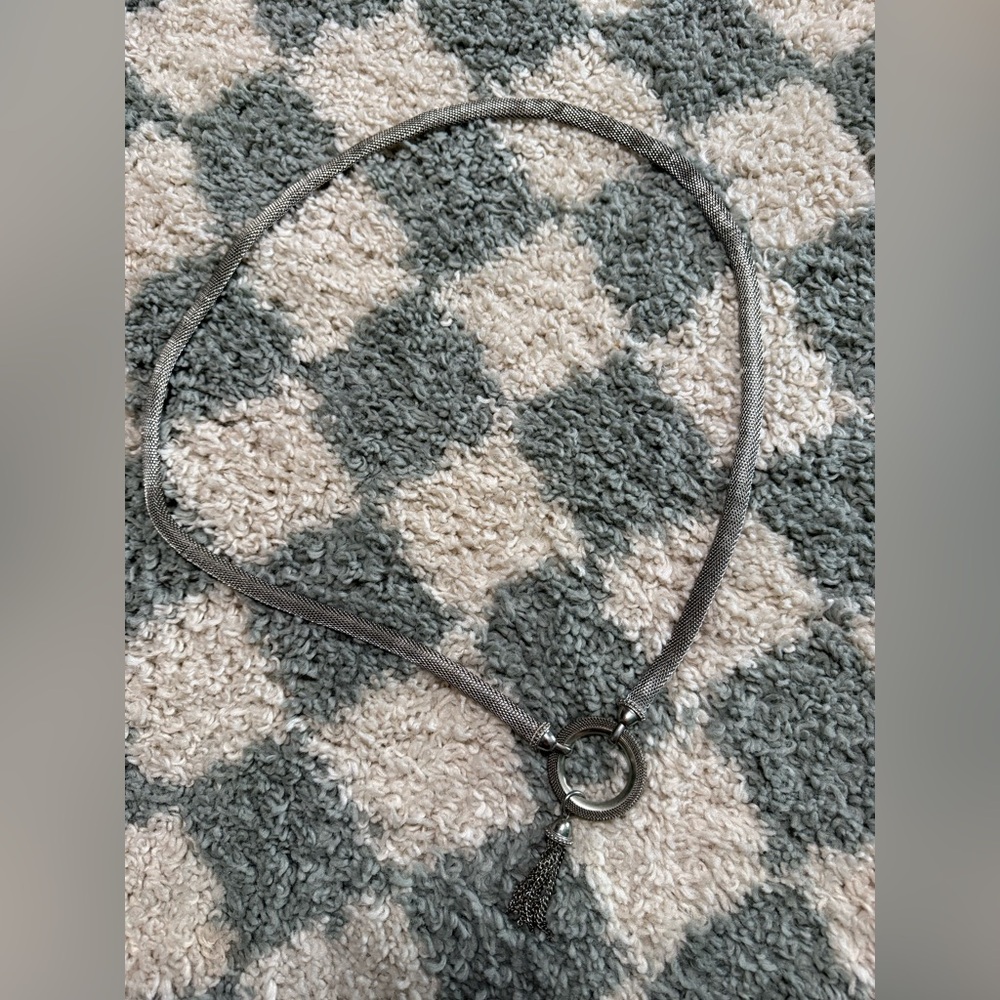 Silver tone chain mail statement belt with tassel and circular latch